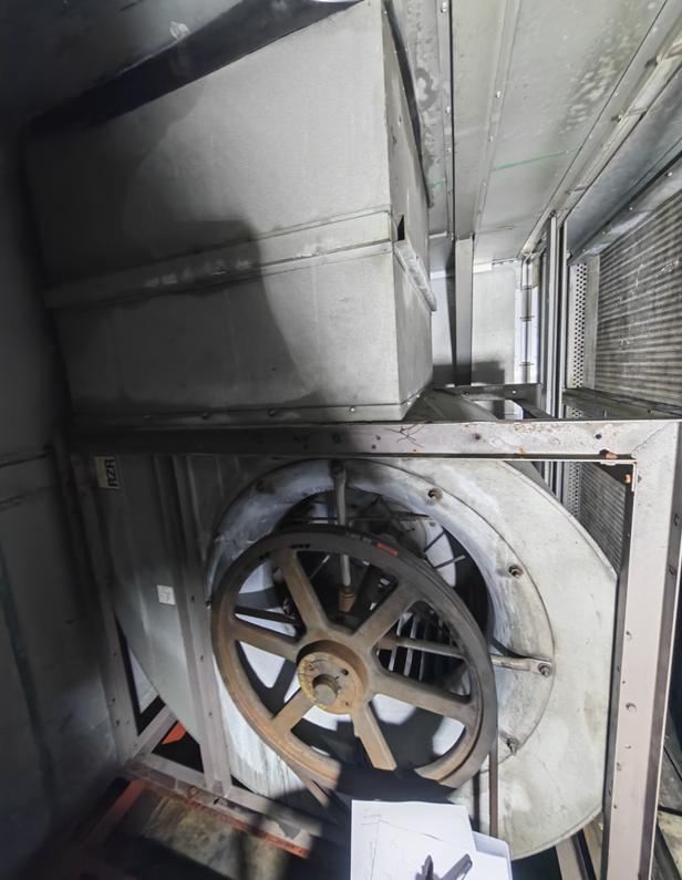 Existing belt-driven centrifugal fan inside an AHU before retrofit